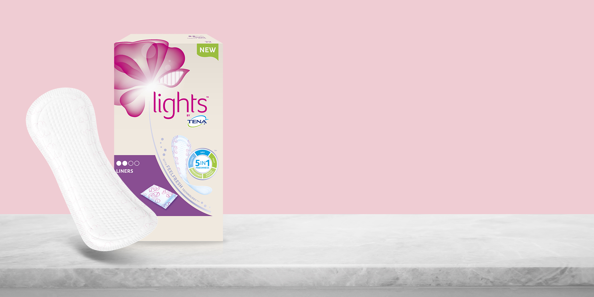 Woman holding up the three different TENA Lights pads Woman holding up the three different TENA Lights pads